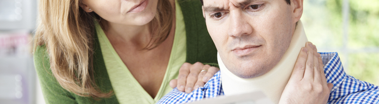 Wife holds husband's shoulder with disability