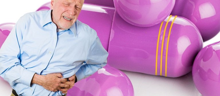 An old man with stomach cancer holding stomach