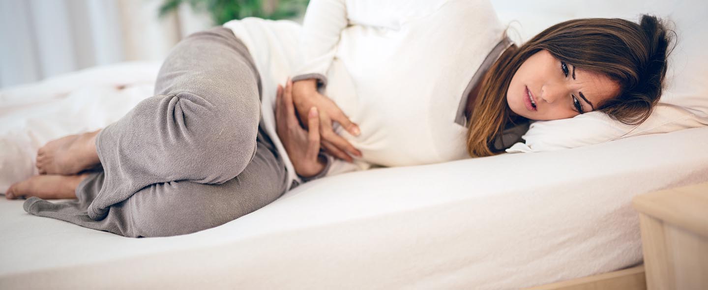 Women holding stomach for pain